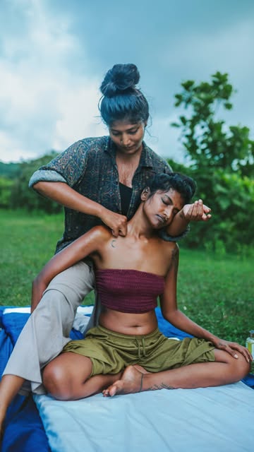 A seated Thai Yoga Massage session outdoors